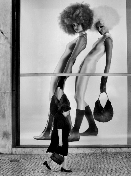 photographer-rui-palha portugal A woman alks past a large billboard of two women with afro hairstyles