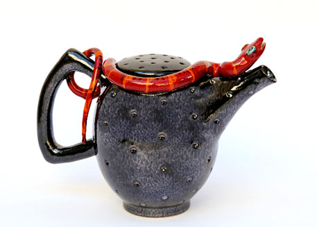 M Morigi 2012 black ceramic teapot with a red snake figurine on the edge