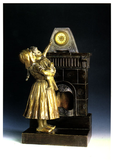 Antique mantle clock of girl holding a child next to the fireplace