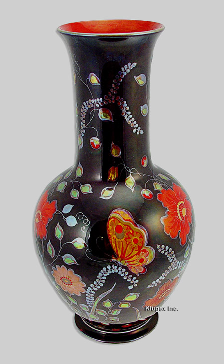 Zsolnay ceramic vase with botanical motifs and ed butterfly motif on a black background