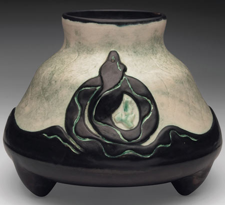Gouda vase, unusual form with carved serpent in black against a green and ivory background
