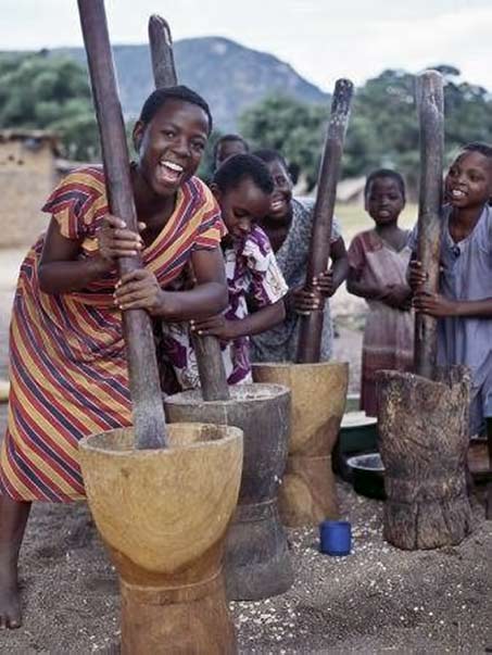 cheerful-young-girls-pound-corn-outside-families-homes-near-monkey-bay-south-end-of-lake-malawi-photo-by-nigel-pavitt