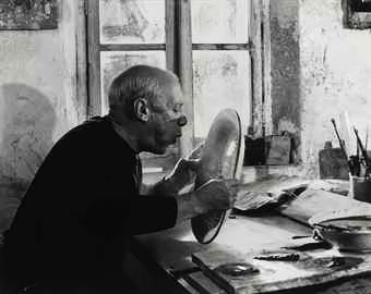 Pablo Picasso painting a charger in his Vallauris studio