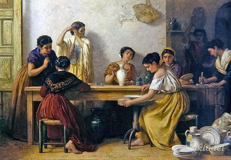 women seated at a table decorating pottery