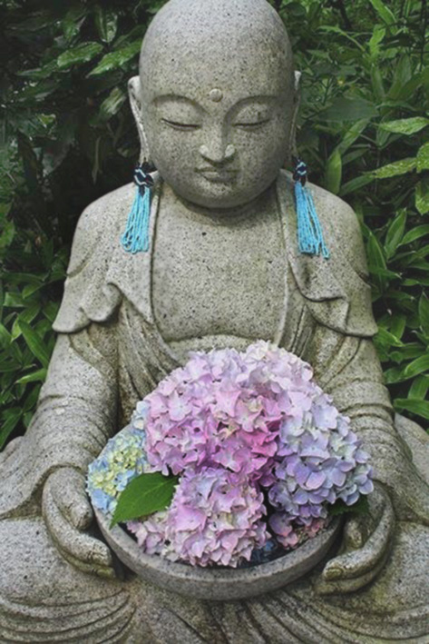 Jizo Japanese garden statue holding hydrangeas