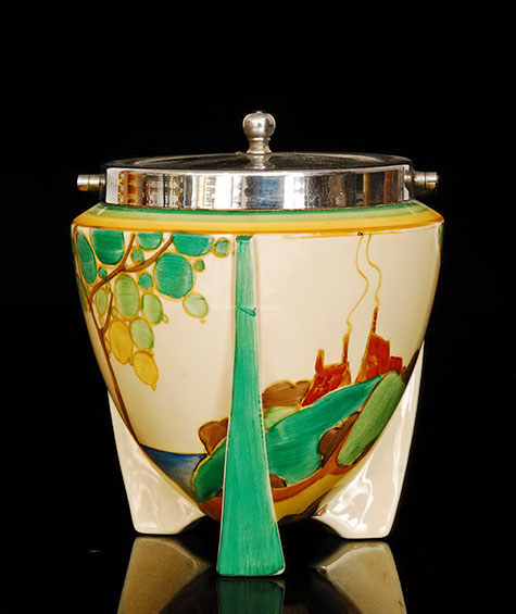 Clarice-Cliff---Secrets---A-shape-478-bomb-biscuit-barrel-circa-1933-hand-painted-with-a-stylised-tree-and-cottage-landscape-below-chrome-plated-mounts,-Bizarre-mark,-height-13cm