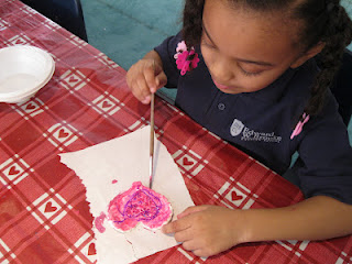 A girl painting a heart