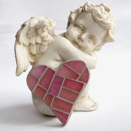 White ceramic cherub with pink mosaic heart