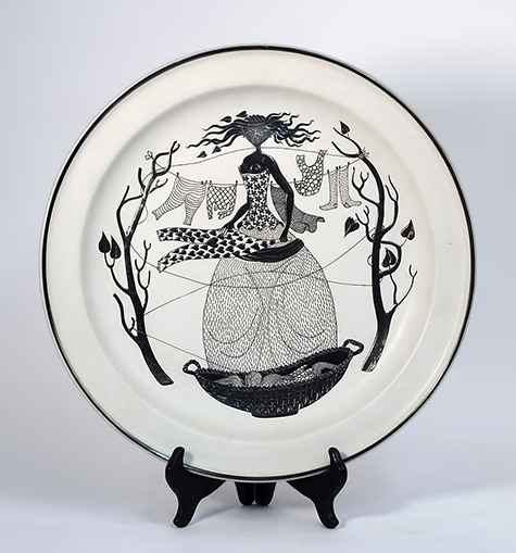 Stig Lindberg dish for Gustavsberg with illustration in black on white of a girl hanging clothes