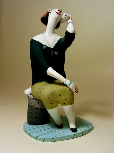El Innocent - pottery figurine of seated lady talking on the phone