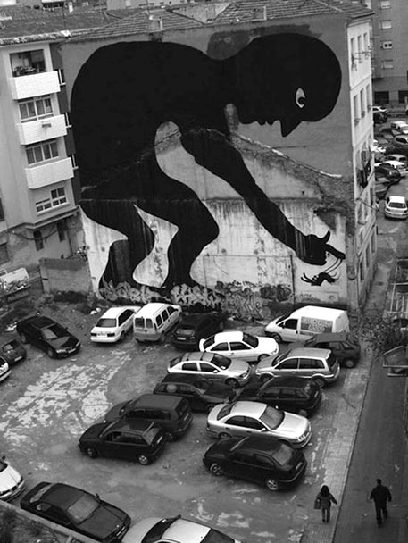 Spanish street art - large silhouette of a man on the side of a building