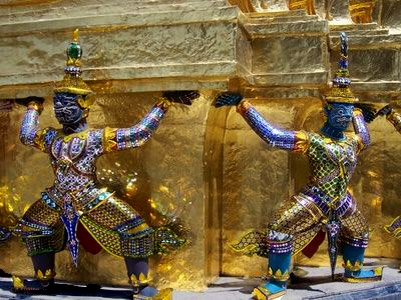 Two Thai temple statues in blue and gold