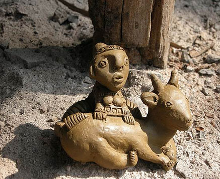 clay figurine of a cow and a child