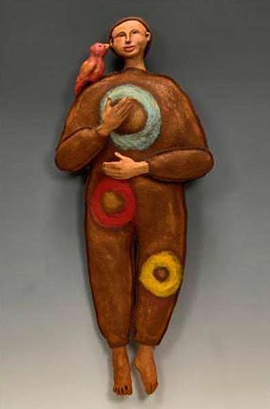Brenna-Busse wall sculpture of man with a bird on his shoulder