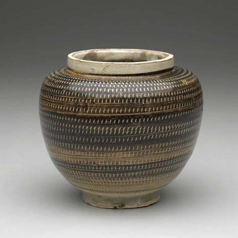 this jar is ornamented in the scraffito manner with an olive-brown overslip carved through to a white slip