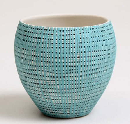 turquoise pot with geometric patterned surface