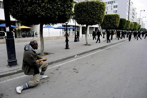 Spring Uprising Tunisia kneeling man confronts troops