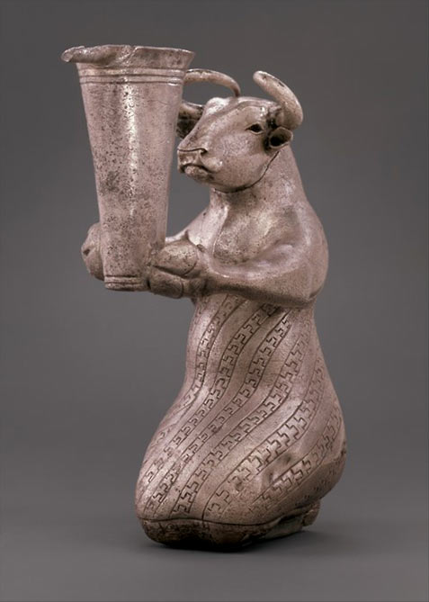 Kneeling bull holding a spouted vessel artifact from Iran