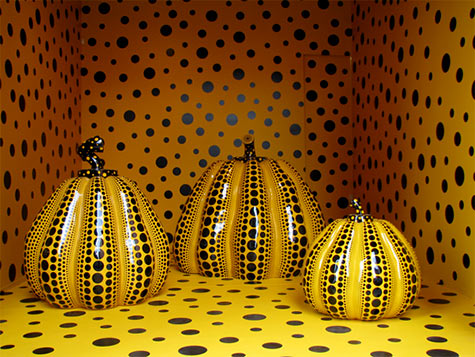 Yayoi Kusama black Polka Dots sculpture on yellow