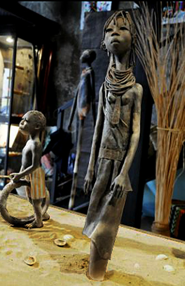 Michele Ludwiczak african sculpture figures in village setting