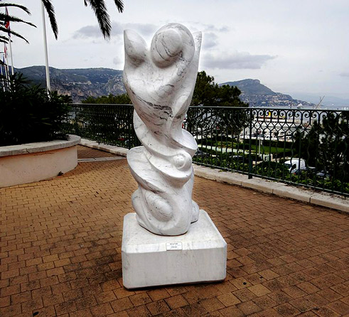 Intuition - Marbre de Erickh White modern sculpture on a balcony with sea views