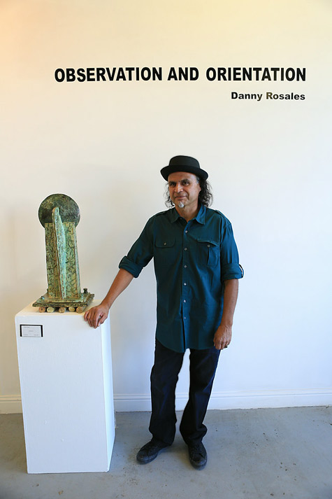 Danny Rosales posing with his sculpture