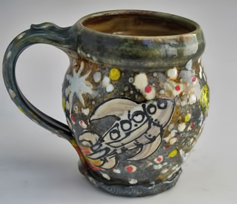 Space-mug-with-astronaut-space-walking-in-stars-and-planets Morris Pottery