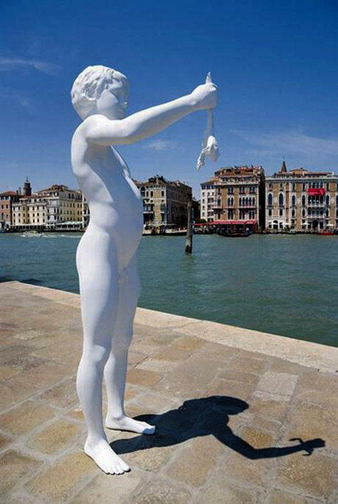 Venice-Biennial sculpture on the Grand Canal White sculpture of a boy holding a frog by Charles Ray