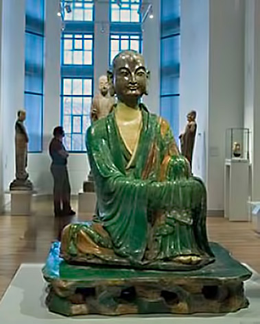 A-green-glazed-ceramic-Yizhou-Luohan-statue-from-the-10th-century-sits-serenely-at-the-gallery's-entrance at the Royal Ontario Museum