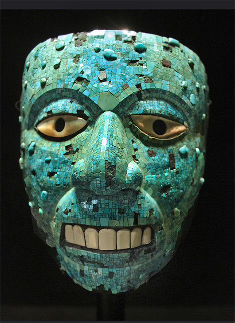 Aztec-turquoise-mosaic-mask---The-mask-is-made-of-cedar-wood-and-covered-with-turquoise-mosaic.-The-elliptical-eyes-consist-of-mother-of-pearl-and-the-teeth-are-made-of-conch-shell