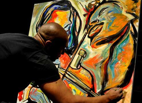 Artist Corey Barksdale at the outdoor live painting event in Atlanta abstract art