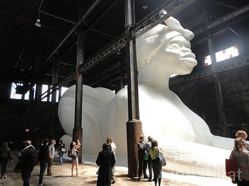 Kara-Walker’s-wildly-popular-“Marvelous-Sugar-Baby”-art-installation-(see-photo-at-left)-at-the-old-Domino-sugar-refinery-in-Brooklyn,