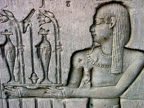 Egyptian wall relief - offering  perfumes and lilly flowers