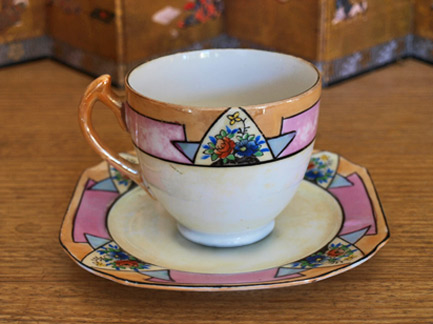 Japanese porcelain translucent cup and saucer - orange and pink on white Art Deco styling