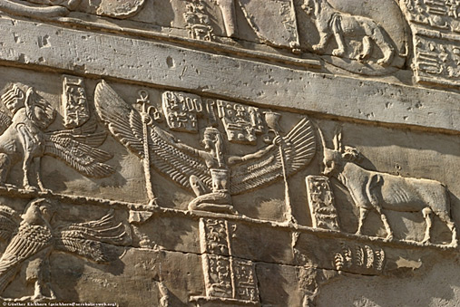 Temple relief of Winged Goddess between the Apis Bull and a winged lion on the left.