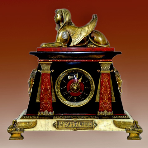 Mantle clock French Antique Egyptian Revival made of bronze and marble adorned with winged sphinx