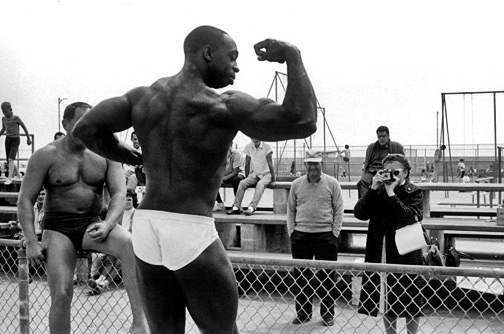 Body Builder in Venice, CA, Posing for a Woman with a Brownie Camera 1964