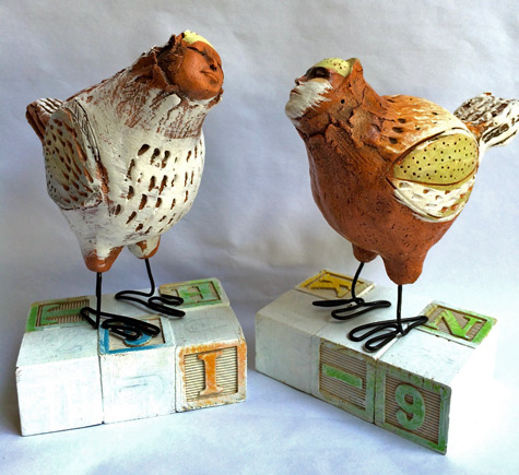 Bird-Folk by Laura Balombini - two earthenware birds with wire legs