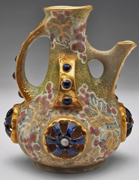 Amphora-handled-vessel,-bulbous-shape-surrounded-by-rosettes-and-applied-stones-in-blue,-painted-grape-motif-on-a-mottled-ground,