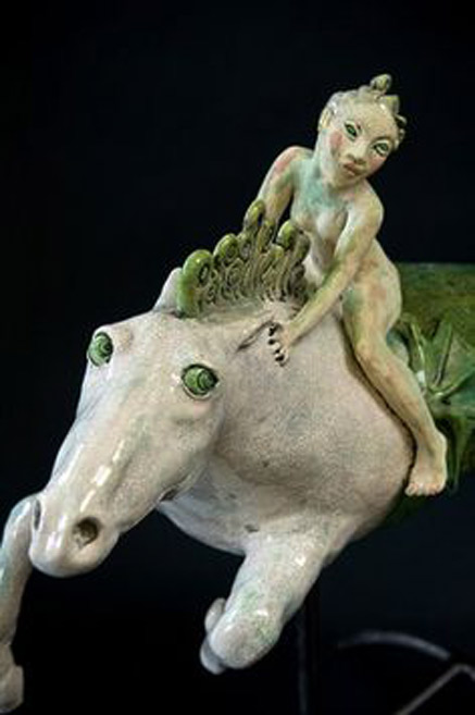 Marie-Prett - nude girl riding a white horse with green eyes
