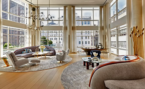 Decorator-Amy-Lau-used-oversize,-theatrical-pieces-by-Vladimir-Kagan-and-Lindsey-Adelman-to-complement-the-19-foot-ceilinged-and-glass-walled-living-room--Manhattan-triplex
