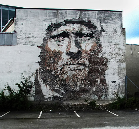 Vhils wall portarit using etching, tearing or acid-burning of the surface