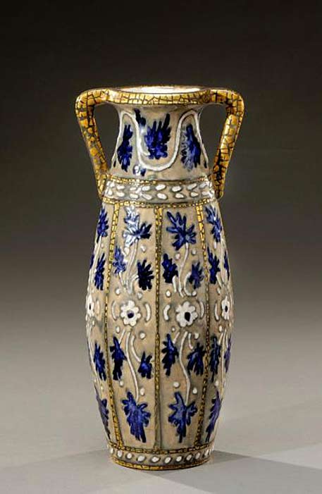. Vase with bulging body and flared neck with two handles under glazed ceramic cracked with a decorative blue and white floral pattern on brown background beige toned and enhanced with gilding