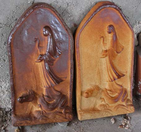 Anne-Shulenberger-Kwan-yin-wall-art wood-fired-Kwan-Yin-sculptures---Anne-Shulenberger wall panel of Kwan Yin riding a dragon