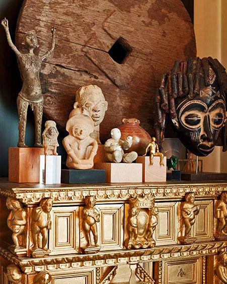 Accessorize-your-Home-african-art-figures with putti relief figure gold cabinet 