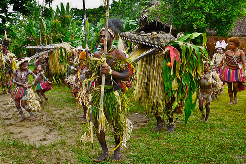 Dance-of-the-crocodile - Crocodile cult dancers parading with a -crocodile sculpture Yentchen - Sepik