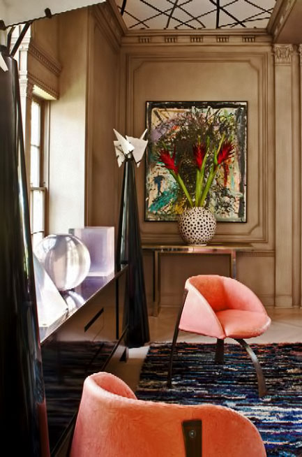 Loft-Concept-Kelly-Wearstler interior with large a pair of black conical sculptures, and white spherical vase with salmon pink chairs