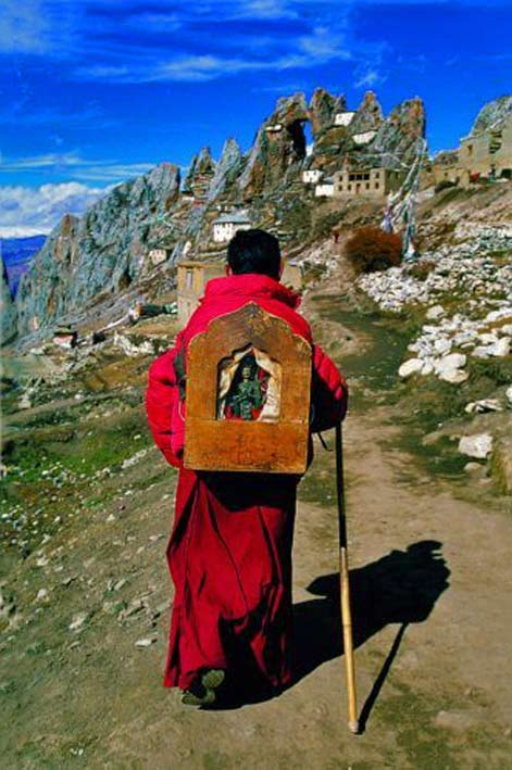 Buddhist-monk-carrying Buddha shrine on his back in-Tibet