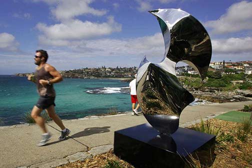 Jeramie Carters-sculpture-the-dancer photo-a-man-runs-past-jeramie-carters-sculpture-the-dancer-as-final-preparations-are-made-ahead-of-the-sculpture-by-sea-art-exhibition-near