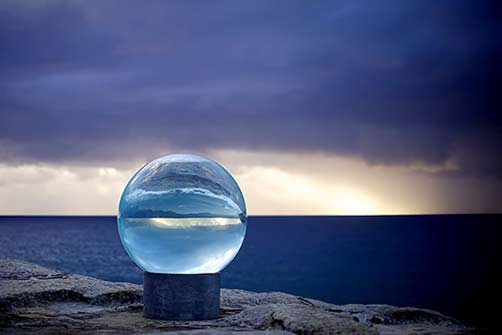 lucy-humphrey-horizon-sculpture-by-the-sea-bondi-2013 large glass sphere on the seaside rocks